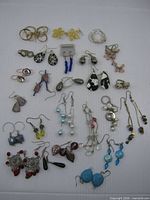 Full group shot showing all 25 earring pairs
