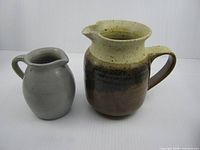 Front view of both creamers side by side