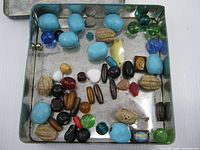 Open tin showing all beads inside