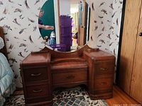 Full front view of the vanity showing mirror, drawers and overall form