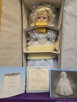 Doll in original box with foam inserts, COA and brochure displayed