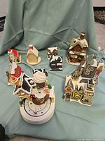 Group shot of all six village structures on cloth