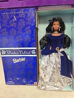 Doll in open box showing full outfit and accessories