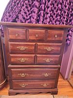 Front view of seven-drawer dresser showing finish and hardware