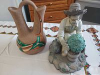 Group view of double-spout vase and gardener figurine