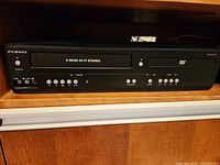 Front view showing both VHS and DVD sections, control buttons and overall condition