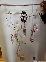 All five mobiles hanging from branch, showing full lot.