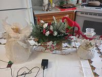 Angel topper, sleigh centerpiece, snowman light and adapter displayed together