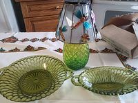 Both olive green dishes and accent lamp displayed