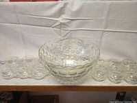 Punch bowl centered with matching cups flanking both sides showing full set
