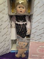 Doll secured in original Knowles box with accessory bear and COA visible