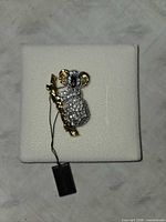 Front view of koala brooch on display pad