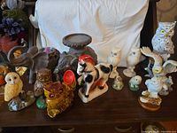 Group view of all ceramic and porcelain animal figurines on table