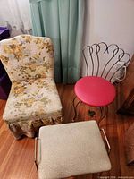 Group shot of floral slipper chair, pink-seat metal vanity stool, beige footstool