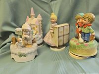 all four figurine music boxes front view