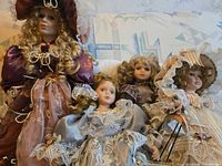 Group shot of four Victorian-style porcelain dolls