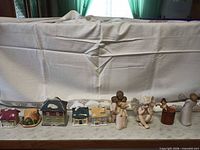 Full lineup of four miniature houses and six angel/cherub figurines