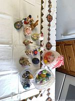 Group shot of all Easter figurines, decorative eggs and baskets displayed on table
