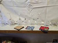 Row of six crystal stemware, three tumblers, four fabric coasters