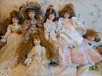 Group shot of all six dolls displaying sizes and outfits