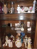 Overall cabinet view showing quantities and variety of porcelain, glass, shell and coral pieces