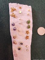 Front view of all stud earrings arranged vertically on paper towel