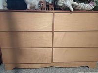 Front view showing six drawers and light wood finish