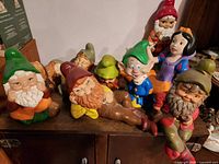 Group shot of all eight figurines on shelf