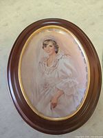Framed oval porcelain portrait plate of Princess Diana in wedding gown