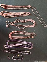 Overview of all jewellery pieces arranged on dark surface