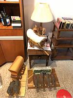 All items in lot: side table, lamp, shelving, and three wagon models with horses