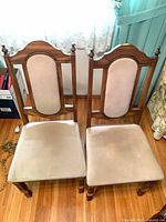 Front view of both chairs showing overall design, upholstery color and wear