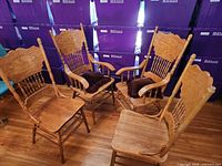 Four matching carved oak armchairs with cushions