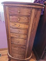 Front view showing drawers and side doors of solid oak jewelry armoire