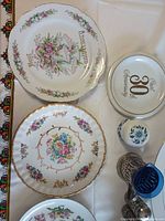 Group of floral plates, 30th Anniversary plate, small jar, metal holders