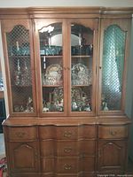 Full view of china cabinet showing upper glass display and lower drawer/cupboard section
