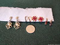 Front view of all four earring pairs with coin for scale