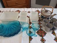 Group shot showing all Pyrex dishes, blue glassware, teapot and mugs