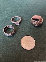 Group of three rings with coin for scale