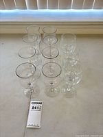 Front angled view of all 11 wine glasses confirming count and condition