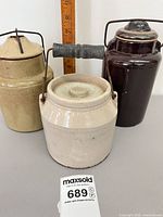 All three stoneware preserving jars front view