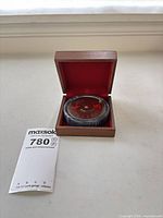 Perpetual calendar in wood box with MaxSold slip visible