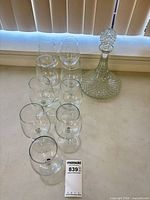 Group view of nine wine glasses and decanter with stopper