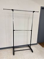 Full view of metal garment rack showing double rails and frame
