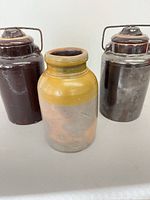 Front view of all three jars showing relative sizes, colours, lids and handles
