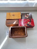 group shot showing four wooden boxes and woven basket