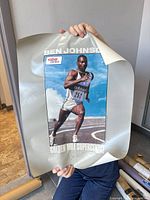 Ben Johnson Golden Mile Supercentre poster held up
