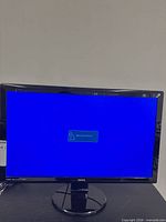 Front view of BenQ monitor powered on showing blue screen