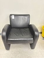 Front view of black leather armchair