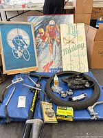 Overview of lot showing signage, exercise mat, pump, bike holders and miscellaneous cycling items